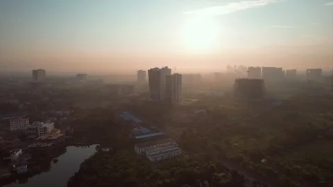 Aerial view of a misty sunset sky over the skyline of Kolkata, India Stock Footage 225094723