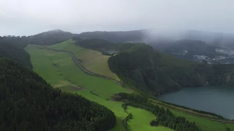 Aerial View of Misty Valley Overlooking Lush Green Fields and Serene Lakes in 库存影片 301734500