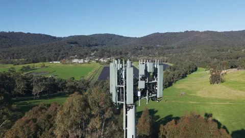 Aerial view of a mobile communication tower in a rural landscape Stock Footage 341233124