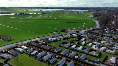 Aerial view of mobile home rows surrounded by green fields, intersecting Stock Footage 336928471