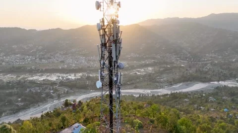 Aerial view of mobile network infrastructure and microwave dishes against a.. Video stock 348470489