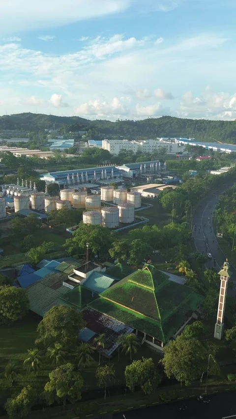 Aerial view of modern architecture nestled among industrial sites and green.. Stock Footage 337284002