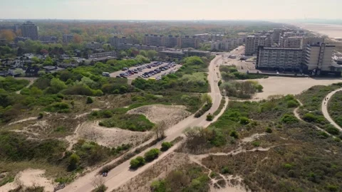 Aerial view of a modern beachside development with apartment buildings, sand Video stock 310879215