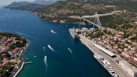 Aerial view of a modern bridge and busy Mediterranean harbor Stock Footage 345118183
