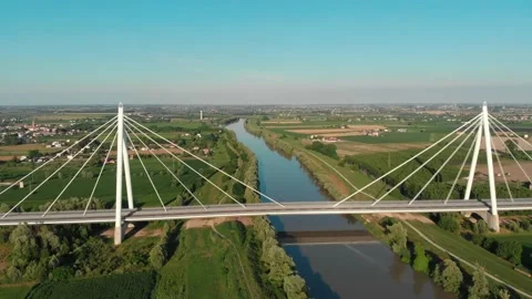Aerial view of a modern bridge over a river in northern Italy. Stock Footage 132859605
