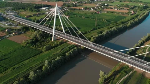 Aerial view of a modern bridge over a river in northern Italy. Stock Footage 132859966