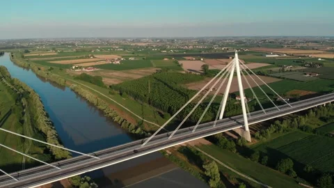 Aerial view of a modern bridge over a river in northern Italy. Stock Footage 132860664