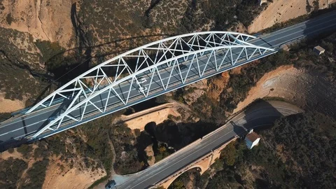 Aerial view of a modern bridge on top of another two older bridges from Vídeos de archivo 99421653