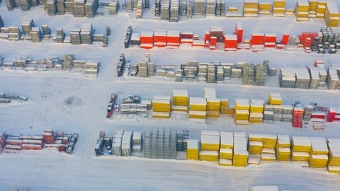 Aerial view of a modern bright building and structural materials on storage yard Stock Footage 101032806
