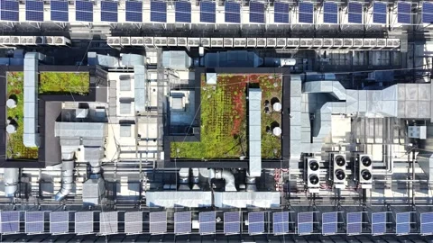 Aerial view of modern building rooftop featuring air conditioning units, solar Stockbeeldmateriaal 341472672