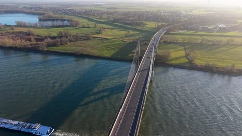 Aerial view of a modern cable stayed bridge over a wide river. Industrial 動画素材 329428889