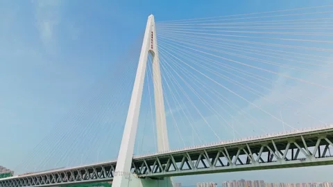 Aerial view of a modern cable-stayed bridge over a wide river Stock Footage 330589276