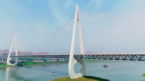 Aerial view of a modern cable-stayed bridge over a wide river Video stock 330589371