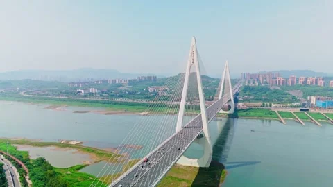 Aerial view of a modern cable-stayed bridge over a wide river Video stock 330589448