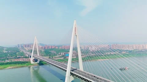 Aerial view of a modern cable-stayed bridge over a wide river Stock Footage 330589455