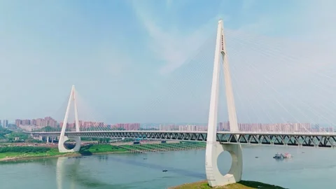 Aerial view of a modern cable-stayed bridge over a wide river Stock Footage 330589472
