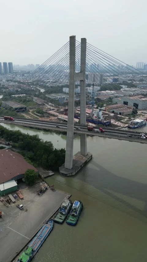 Aerial View of a Modern Cable Stayed Bridge Over a River in Ho Chi Minh City, Video stock 335576858