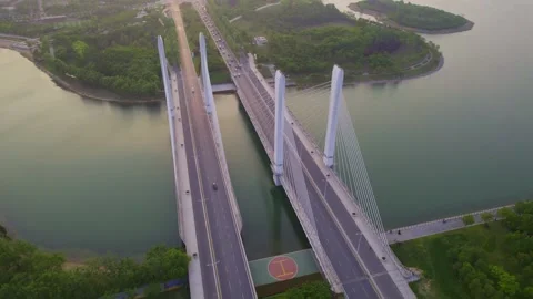 Aerial View of Modern Cable-Stayed Bridge Over Calm River at Golden Hour 動画素材 337420808