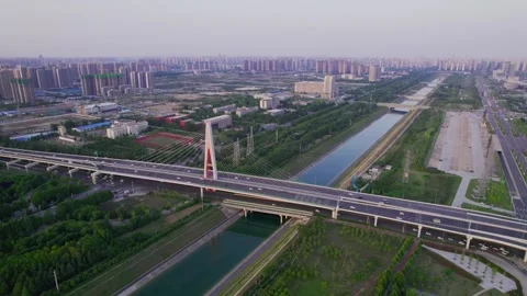 Aerial View of Modern Cable Stayed Bridge Over Canal with City Skyline 動画素材 337421570