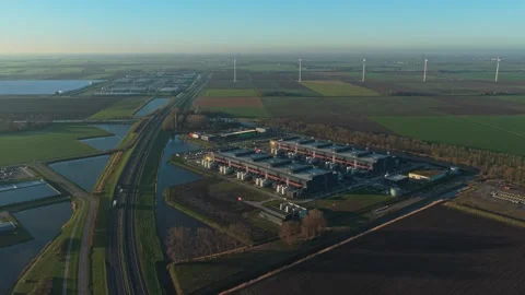 Aerial view of modern data center and wind turbines at sunrise Stockbeeldmateriaal 331201412