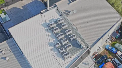 Aerial View of Modern Data Centre Rooftop with Industrial HVAC Cooling Units Stock Footage 342037035