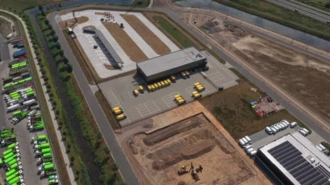 Aerial view of a modern distribution center with yellow delivery vans Stock Footage 341875089