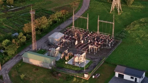 Aerial View of Modern Electrical Substation at Sunset in Lush Rural Countryside Stock Footage 342025679