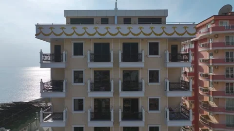 Aerial View Modern Facade Overlooking the Sea with Clear Skies Captured from Stock Footage 300971404
