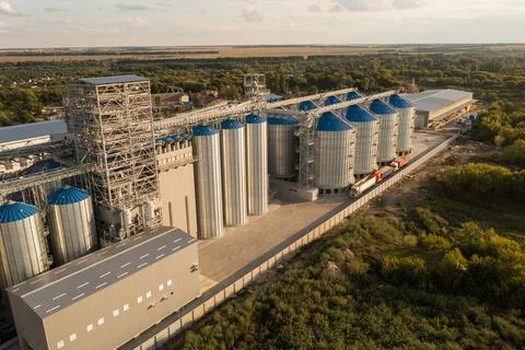 Aerial View of Modern Grain Elevator and Silos with Trucks in Rural Area Ag.. Stock Photos