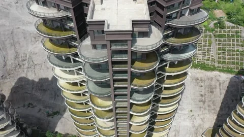Aerial View of Modern High-Rise Apartment Building with Circular Balconies 스톡 동영상 345158111
