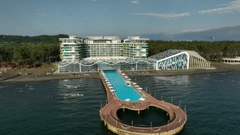 Aerial view of Modern hotel Paragraph with a huge swimming pool going to the sea Stock-Footage 319068005