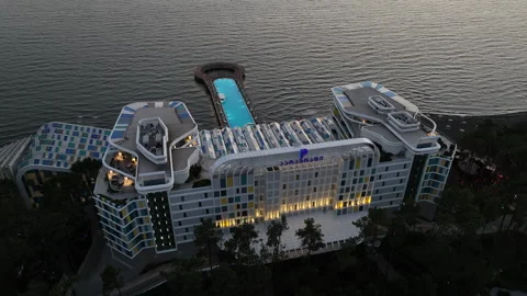 Aerial view of Modern hotel Paragraph with a huge swimming pool going to the sea Stock-Footage 319076548