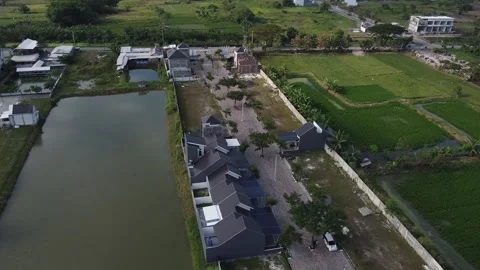 Aerial View of Modern Housing Development with Green Fields and Water Stock Footage 316488051