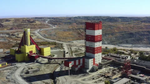 Aerial view of a modern mining facility with red and yellow structures and Stock Footage 285029037