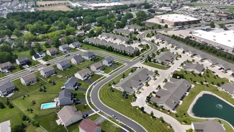 Aerial view of a modern residential complex with winding roads, manicured lawns, Stock Footage 311804768