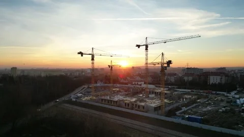 Aerial view of modern residential complex construction with cranes at sunset Stock Footage 323384110