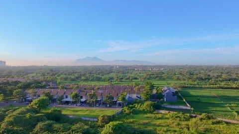 Aerial view of modern residential complex next to green rice fields. Stock Footage 323926840