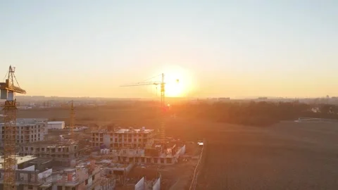 Aerial view of modern residential complex construction with cranes at sunset Video stock 330534723