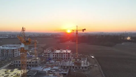 Aerial view of modern residential complex construction with cranes at sunset Video stock 330534941