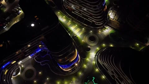 Aerial view of a modern residential complex illuminated at night, showcasing Stock Footage 335886432