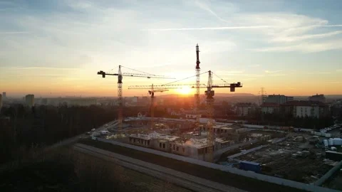 Aerial view of modern residential complex construction with cranes at sunset Stock Footage 335887074