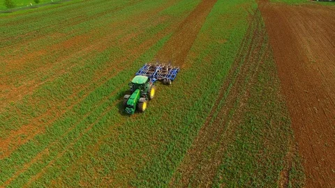 Aerial view of a modern tractor plowing a dry field in spring Stock Footage 89323459