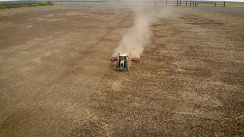 Aerial view of modern tractor processes dry land in farmland food processing Stock Footage 119120883
