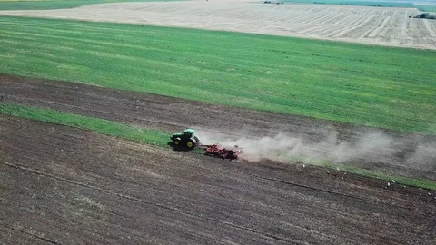 Aerial view of a modern tractor working in the field. Top view Stock Footage 115846235
