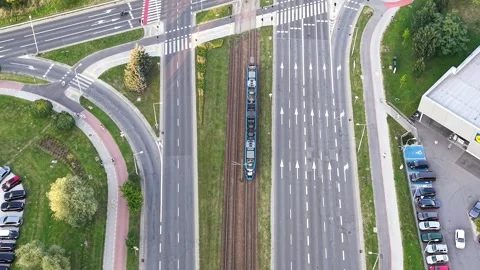 Aerial view of a modern tram navigating through a busy city intersection Stockbeeldmateriaal 340978353