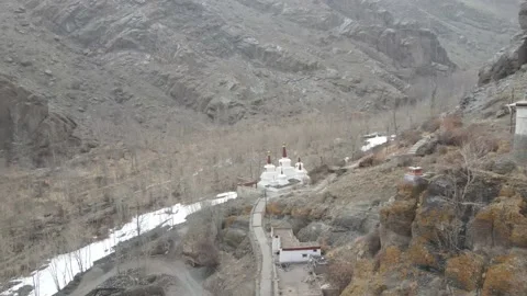 Aerial view of a monastery situated in between the mountains of Ladakh with s Stock Footage 153805129