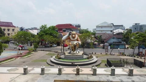 Aerial view of the monkey statue as a typical monument in Banjarmasin in th.. Stock Footage 254455196