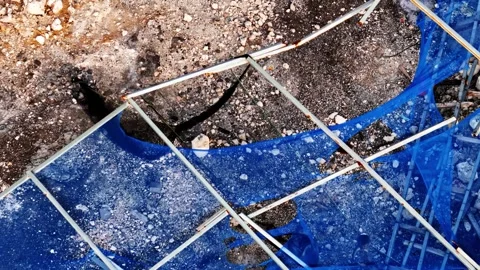 Aerial view of monkeys on blue netting at Uluwatu Beach, Indonesia. Stock Footage 345035970