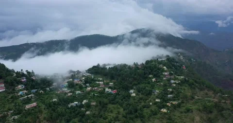 Aerial View Of Monsoon Clouds Locked Behind A Himalayan Village - Full Stock Footage 154859685