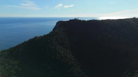 Aerial view of "Monte di Capo Noli", from a drone that increases its altitude Stock Footage 328243144